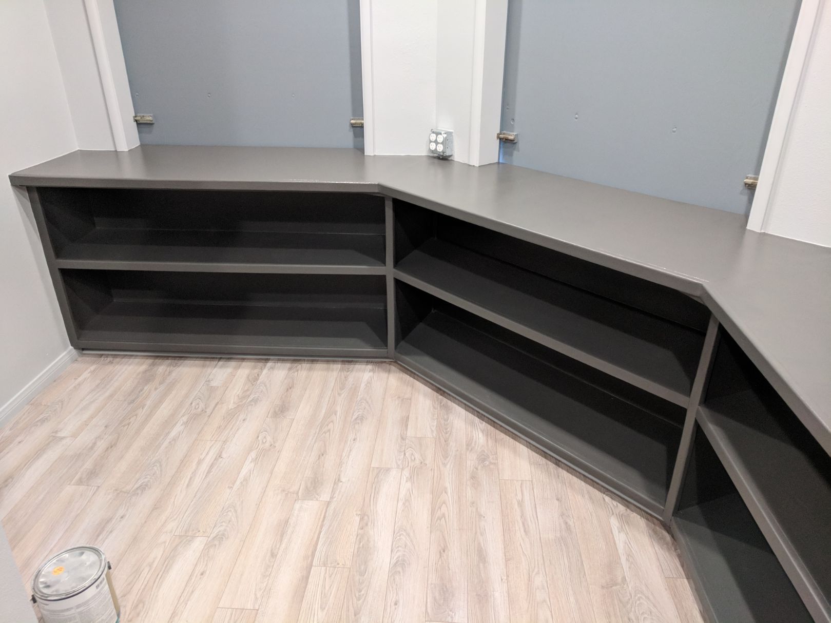 Custom gray corner shelving unit installation