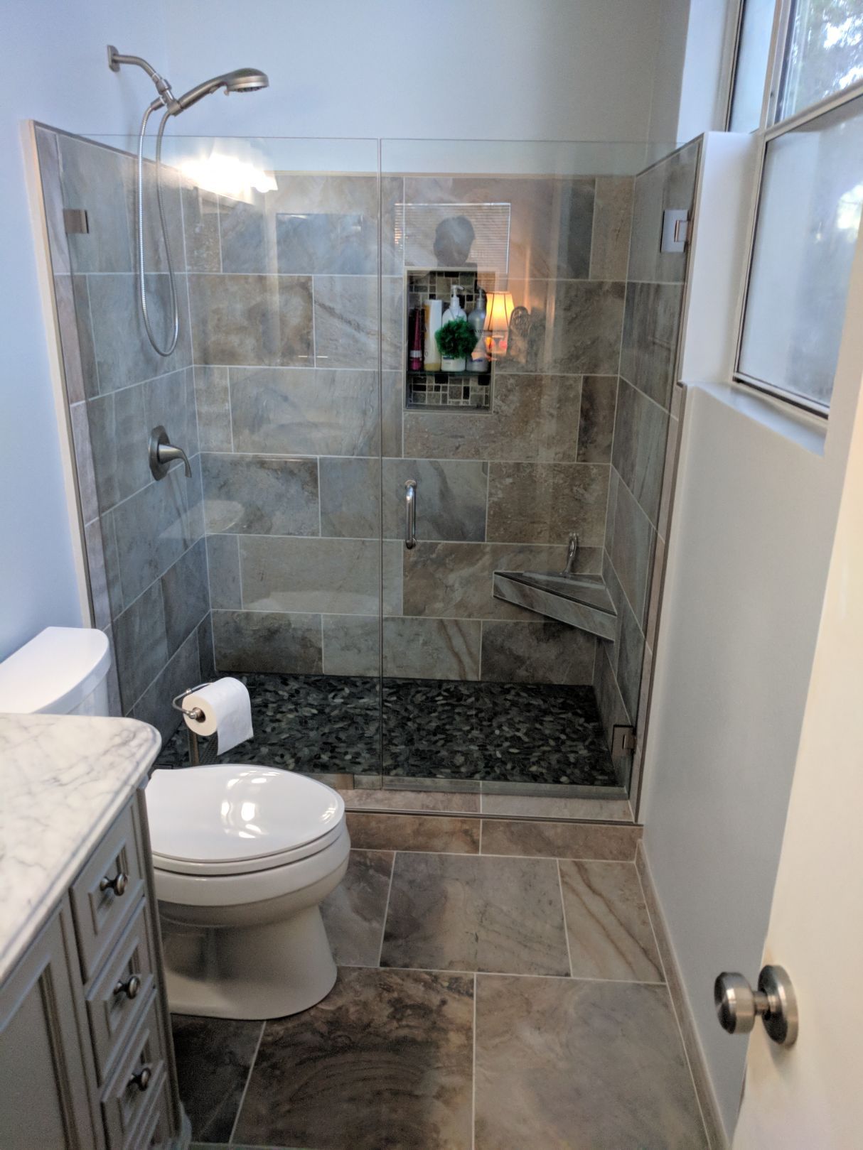 Modern bathroom with tiled shower and floor