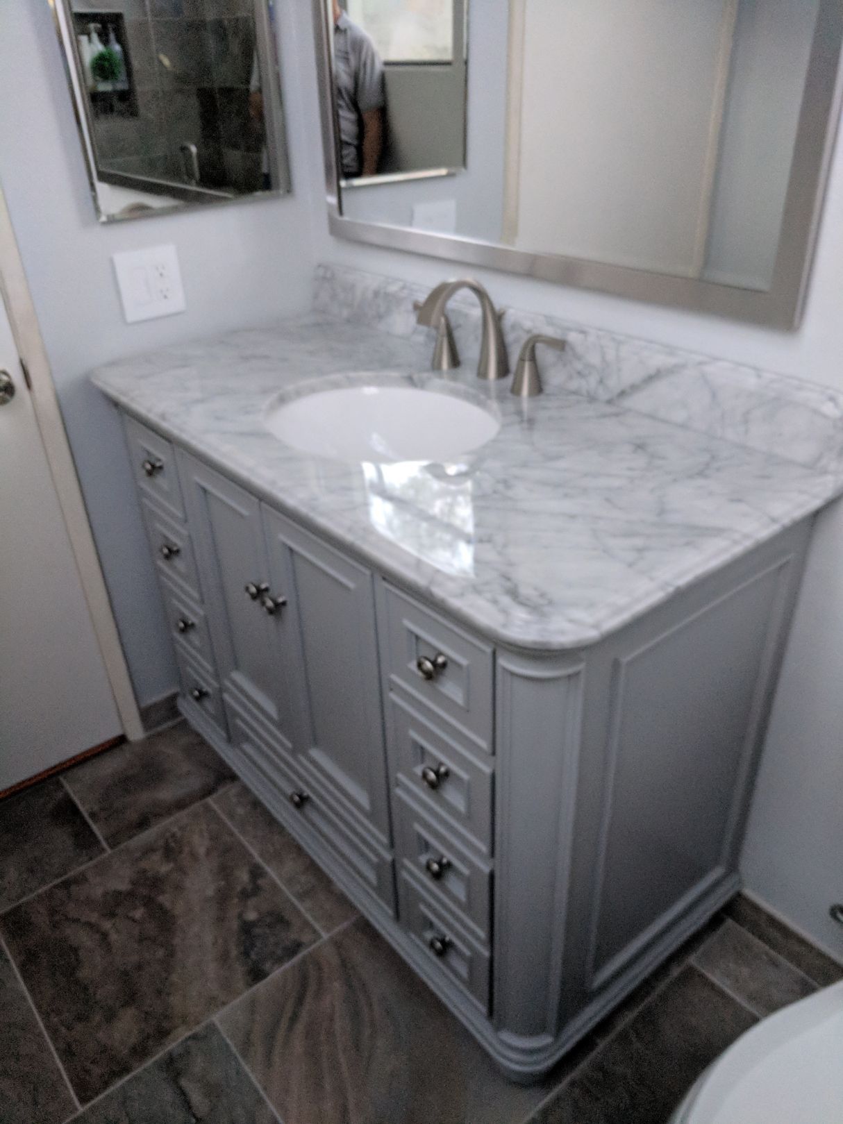 Bathroom vanity with marble countertop and tiled floor