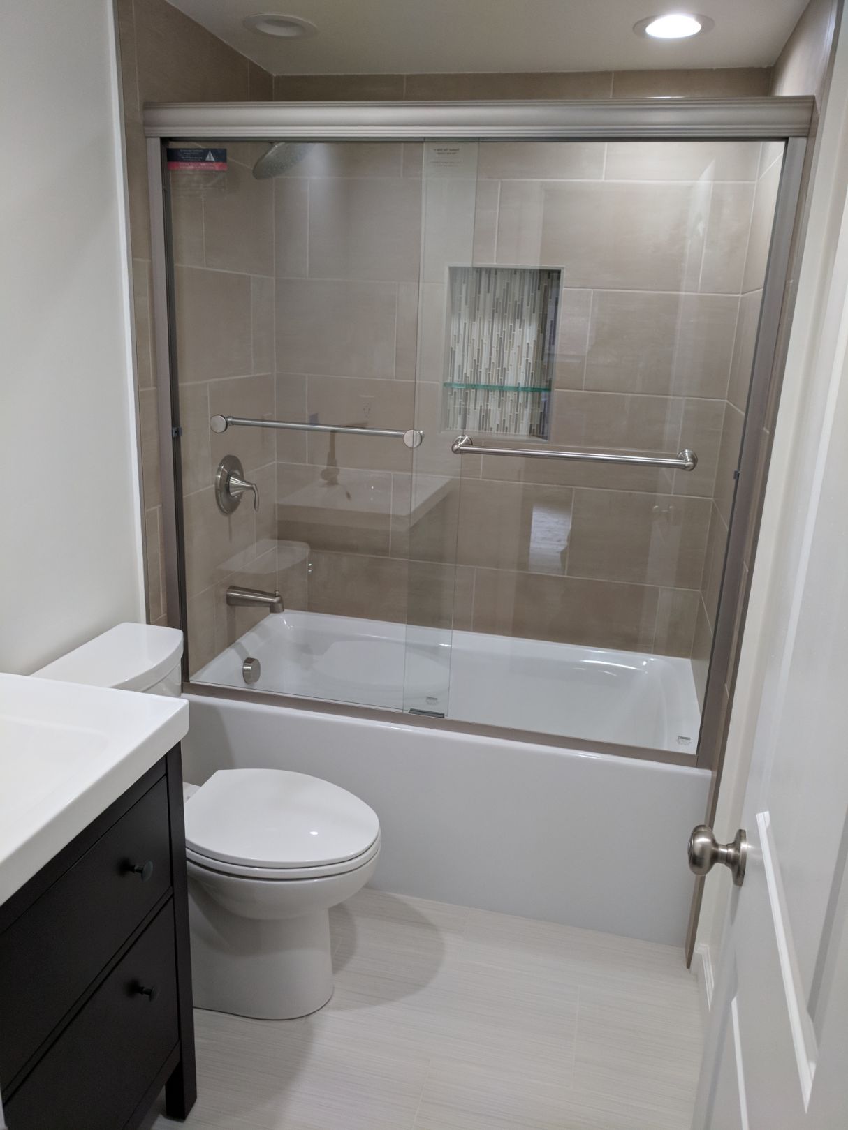Modern bathroom renovation with new fixtures and tiling